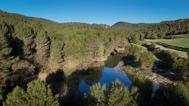 Aerial drone view of Lake Manzano between Bullas and Mula, Murcia Region, Spain, with the Sierra de Burete mountains in the background.