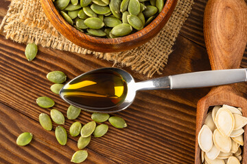 Pumpkin seeds oil on wooden background