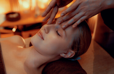 Closeup caucasian woman enjoying relaxing anti-stress head massage and pampering facial beauty skin...