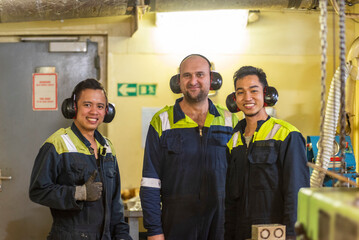 A marine engineers stands in the engine room workshop. The scene captures a moment of preparation, as the officers readies for hands-on work.