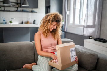 one happy woman open mail cardboard package box present at home