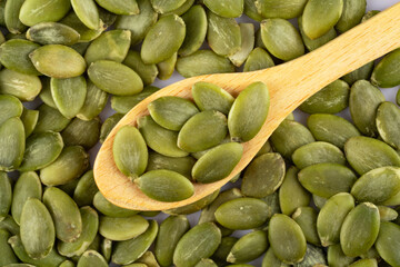 Delicious pumpkin seeds on white background