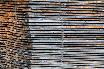 the details of a stack of wooden planks, a lumber drying setup.