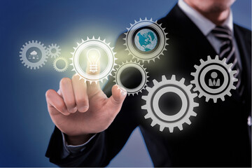 businessman pushing a gear