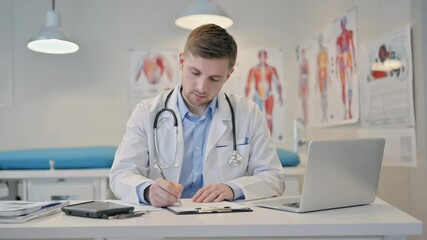 Focused and attentive, the doctor records detailed notes on a clipboard during a patient consultation, ensuring accurate diagnosis and personalized treatment.


