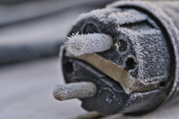 black icy power plug with visible ice crystals