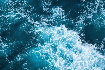Fototapeta premium Aerial view of ocean waves with white foam crashing and swirling in deep turquoise water, digital art style on abstract aquatic background. Ai generative