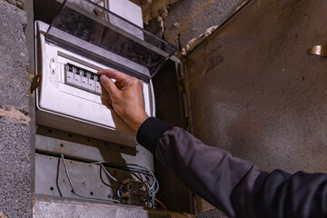 Old electrical fuse box on the wall in the basement, removing power failure in an old house