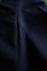 a macro photo of blue pinstripe trousers fabric