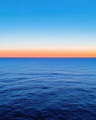 Obraz premium Serene ocean view during sunset with gradient sky evoking calmness and tranquility in a minimalist style