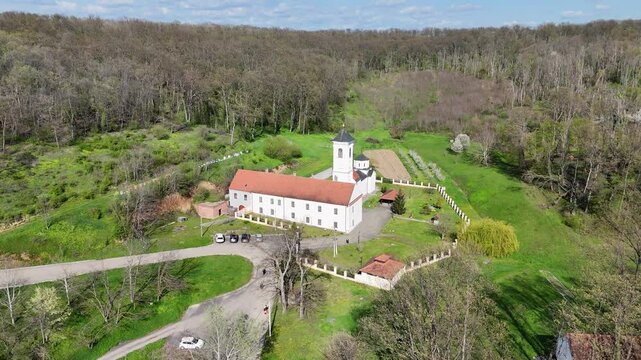 Aerial View of Orthodox Monastery with Garden Path Surounded by Autumn Forest