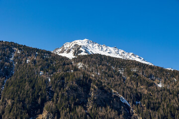 Snow-covered mountain and alpine forest edge in early spring, Ötztal, Austria, 20 March 2025..
