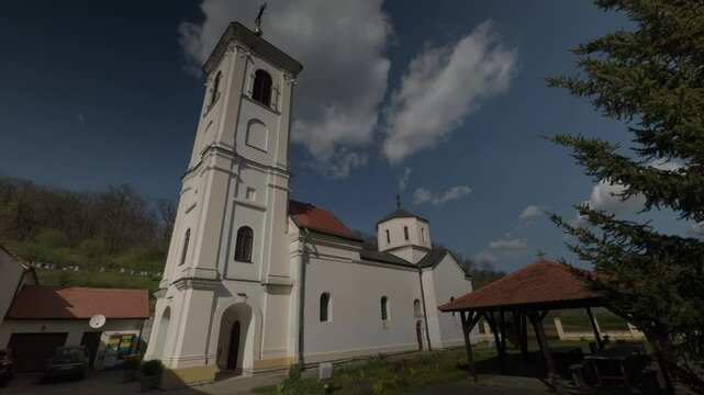 Orthodox Church with Tall Bell Tower and Dome Blue Sk Background