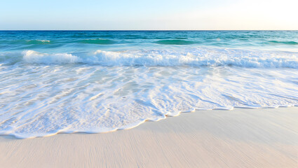 A stunning shot of a beautiful beach with gentle waves and soft white sand.