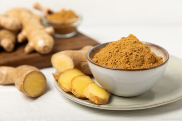 Fresh ginger on wooden background. Dry ginger. Sliced ​​ginger with honey and lemon. Ginger root. Traditional alternative medicine, healing tea for immunity. Seasoning and spices concept. Copy space.