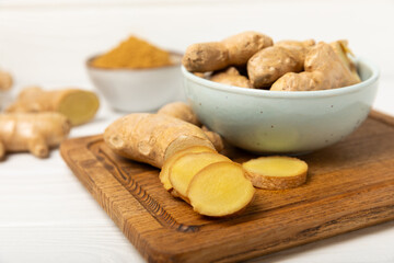 Fresh ginger on wooden background. Dry ginger. Sliced ​​ginger with honey and lemon. Ginger...