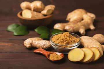 Fresh ginger on wooden background. Dry ginger. Sliced ​​ginger with honey and lemon. Ginger...