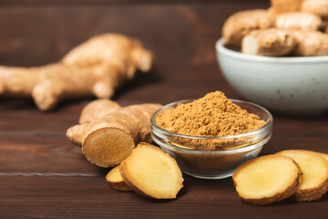 Fresh ginger on wooden background. Dry ginger. Sliced ​​ginger with honey and lemon. Ginger...