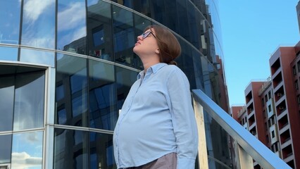 Pregnant sad frustrated woman office worker outdoors 
