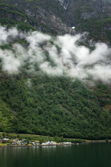 Cloudy landscape with the village over the fjord