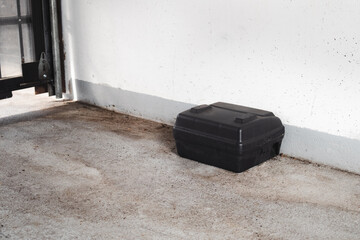Rodent bait station in parking garage entrance. Pest control management in parkade and buildings....