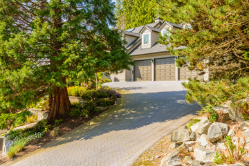 Garage door in luxury house with trees and nice landscape in Summer in Vancouver, Canada, North...
