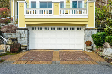 Garage door in luxury house with trees and nice landscape in Summer in Vancouver, Canada, North...