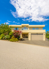 Fototapeta premium Garage door in luxury house with trees and nice landscape in Summer in Vancouver, Canada, North America. Day time on June 2024.