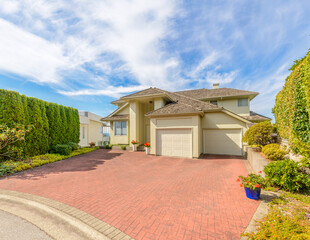 Garage door in luxury house with trees and nice landscape in Summer in Vancouver, Canada, North...