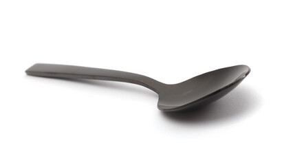 Close up metallic gray black spoon with light shadow on white. Top view.