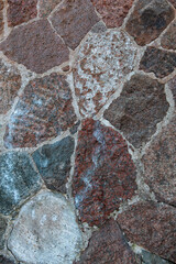 Rustic stone wall showing rough granite textures and solid construction