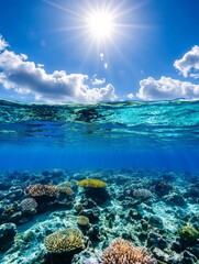 Obraz premium Vibrant Coral Reef Under Sunny Sky - Stunning underwater shot of a vibrant coral reef beneath a bright sunny sky with fluffy clouds. Perfect for travel, nature, or ocean themes