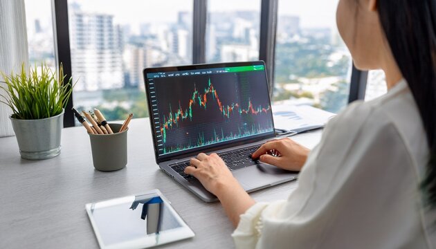Person analyzing stock charts in a notebook