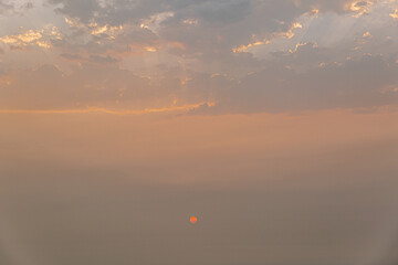 A beautiful sunset with a large orange sun in the sky