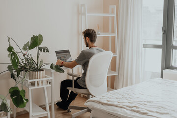 Minimal workspace for a quiet mind. A man works alone in a soft, peaceful space designed for introverts who thrive in calm.