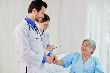A doctor and nurse caring for an elderly patient in a hospital setting, showcasing compassion and...