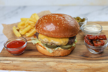 Homemade delicious burger and ketchup, fries.