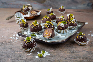 Artisan handcrafted homemade fine dark chocolate pralines with pistachio and coconut chips