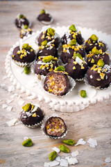 Artisan handcrafted homemade fine dark chocolate pralines with pistachio and coconut chips
