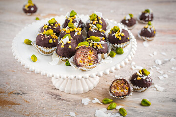 Artisan handcrafted homemade fine dark chocolate pralines with pistachio and coconut chips