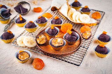 Artisan homemade pralines with dried apricots, fruits and nuts,  coated with fine bitter dark...