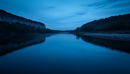 The calm waters Texas' Guadalupe River at night reflect a peaceful, low-light beauty.