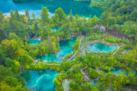 A breathtaking drone photo of the Plitvice Lakes showing vibrant turquoise lakes, lush greenery, and cascading waterfalls in one of the most popular tourist destinations in Croatia