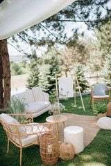 Elegant outdoor lounge with wicker furniture and easel