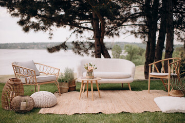 Elegant outdoor lounge with wicker furniture and lake view