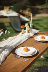 Elegant outdoor table setting with orange dahlia