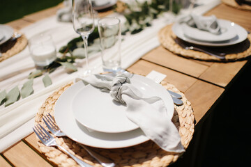 Elegant outdoor wedding place setting with white ribbon