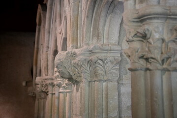 Stone columns with intricate carvings at the medieval fortress and citadel of Carcassonne, France - architectural details from the historic landmark and tourist attraction