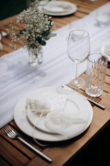 Elegant outdoor wedding place setting with white ribbon