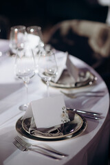 Elegant indoor wedding table setting with white and green elements
